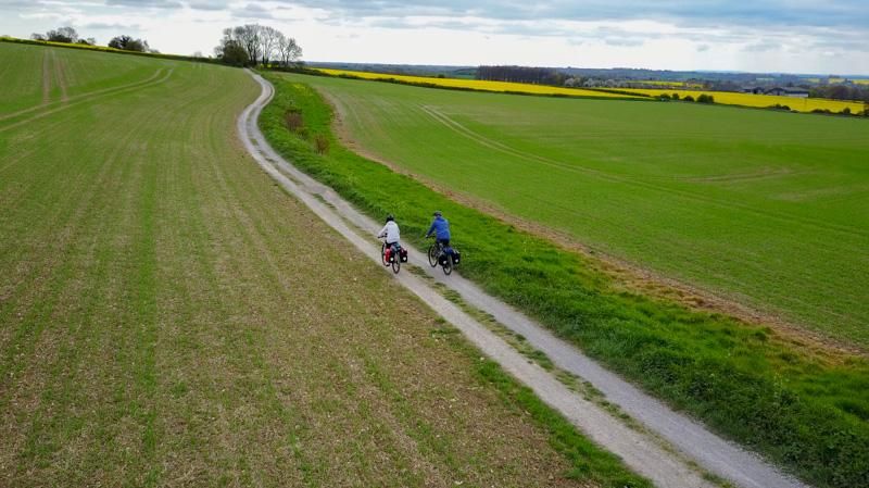 A couple of cyclists cycling in the countryside in Kent, England