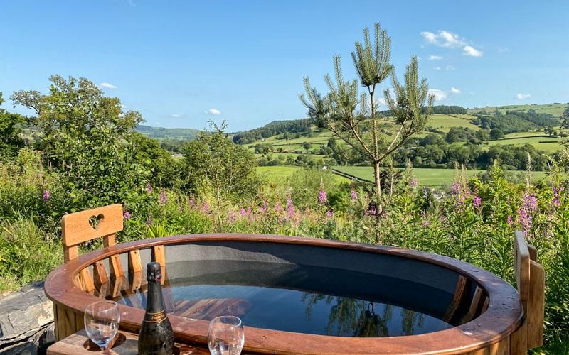 Hot tub overlooking lush hills in Wales